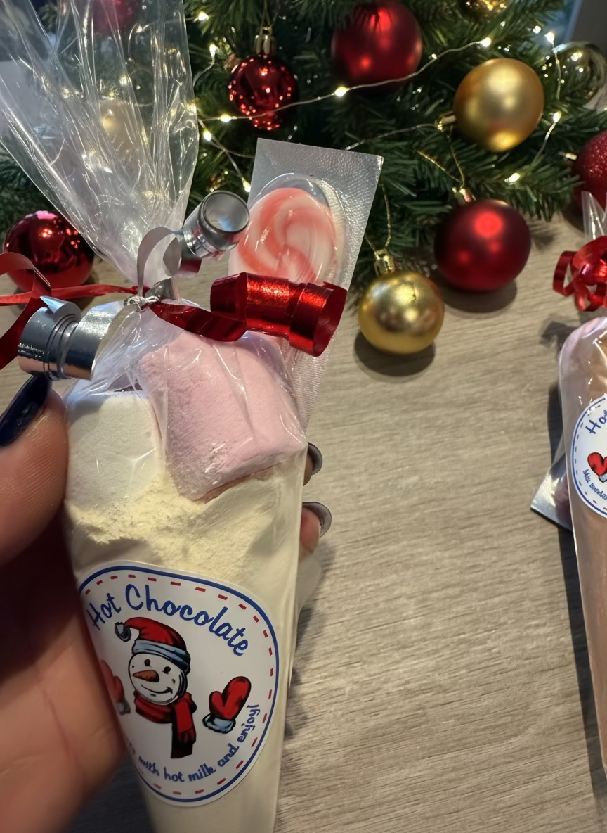 Milk chocolate and white chocolate hot chocolate cones with candy cane stirrer